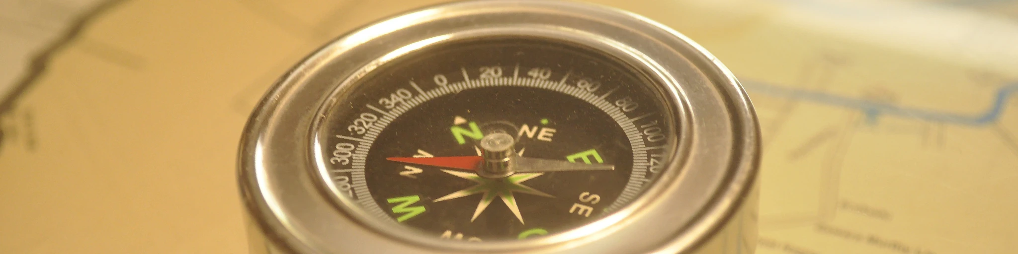 a close up of a compass on a map