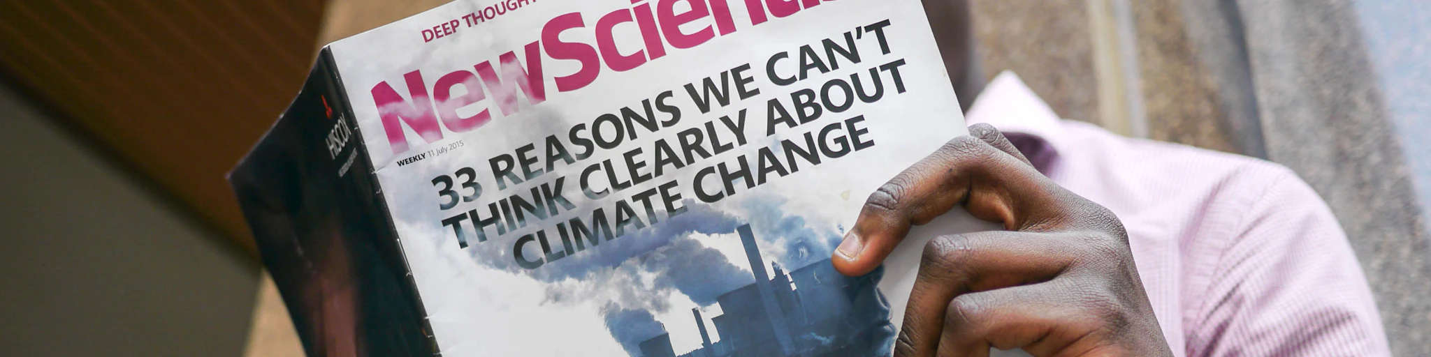 man reading New Scientist book