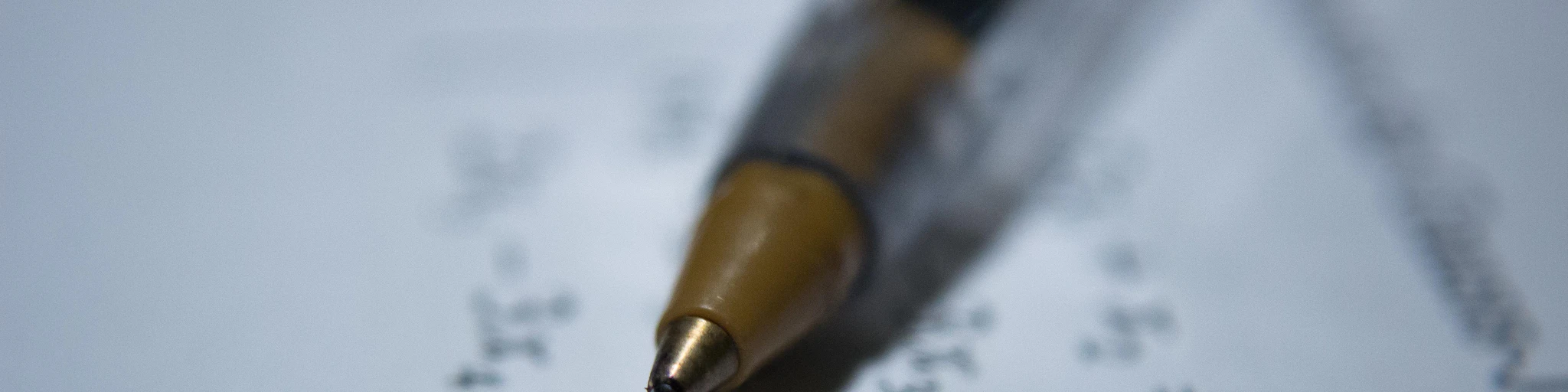 black retractable pen on white printer paper