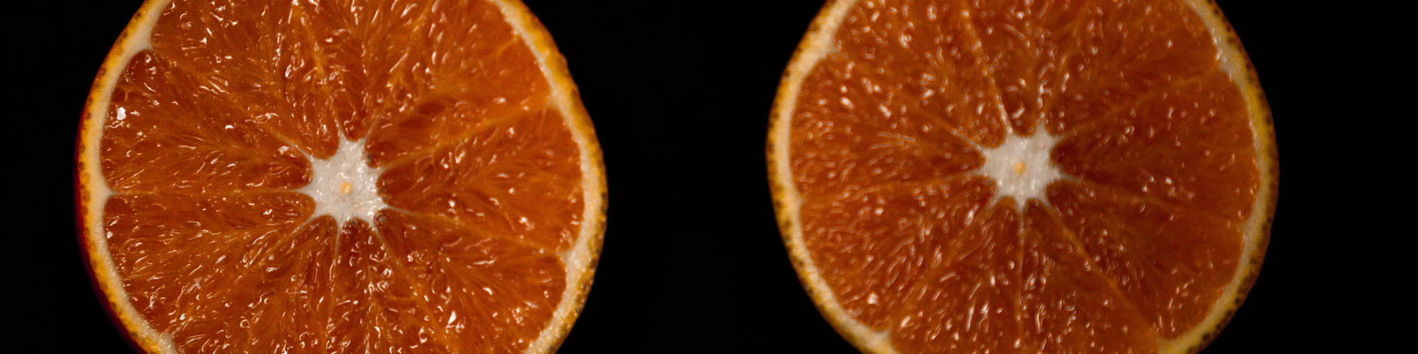 sliced orange fruit on black background
