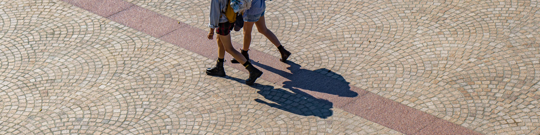 four women walking in street during daytime
