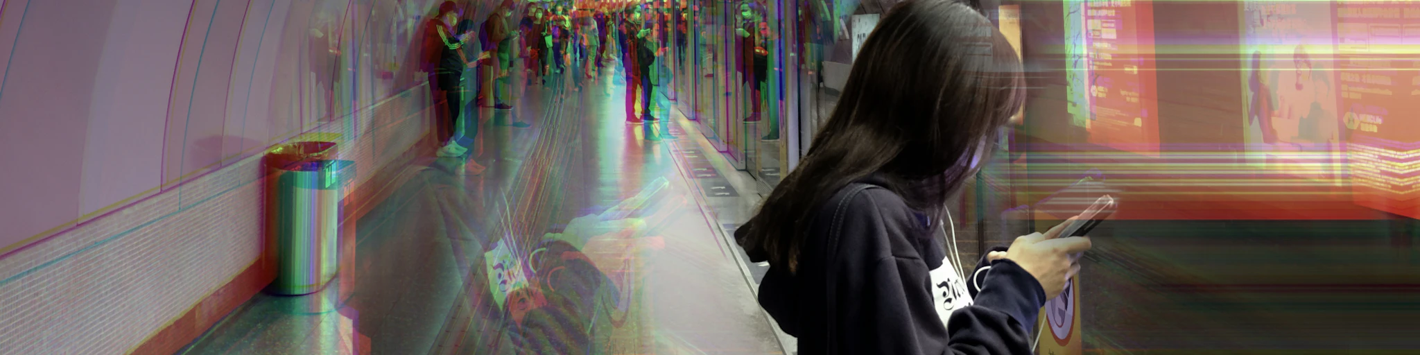 woman in gray hoodie standing in front of train