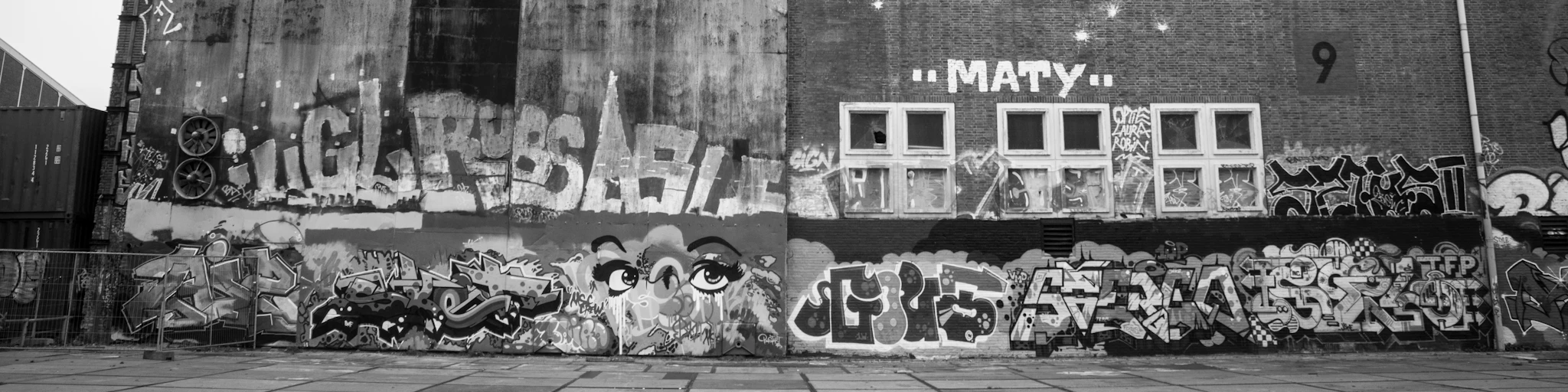 a black and white photo of a building with graffiti on it