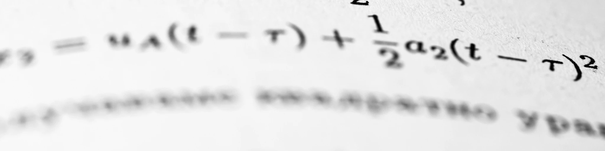 Mathematical formulas are written on the paper.