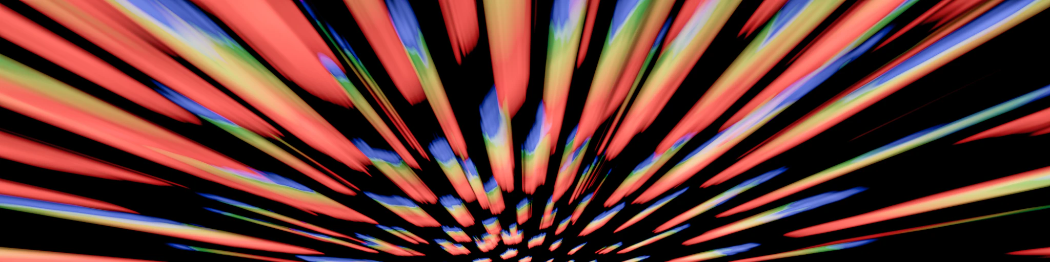 An abstract image of a starburst in red, blue, and yellow