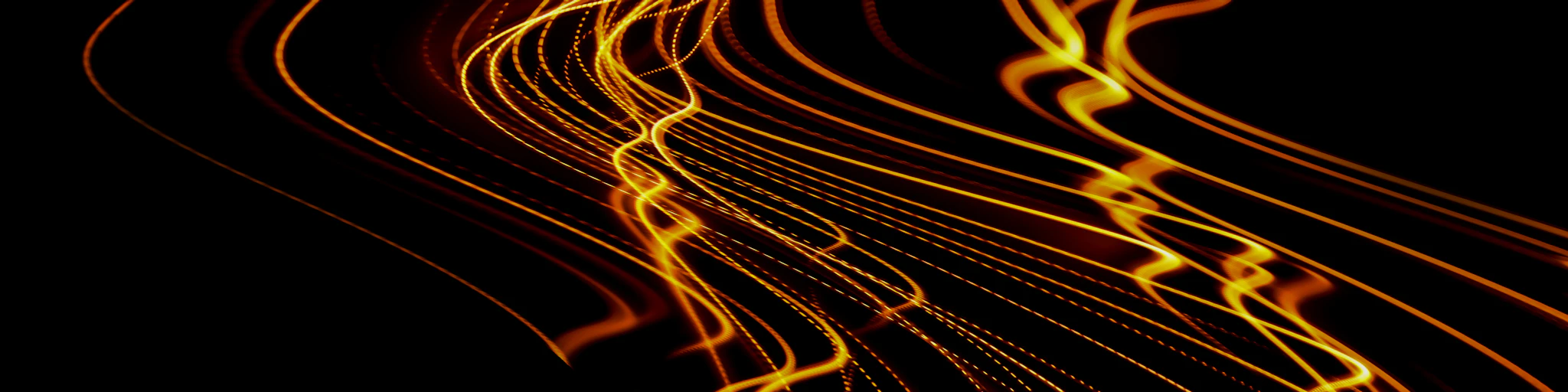 a long exposure photo of yellow lines on a black background