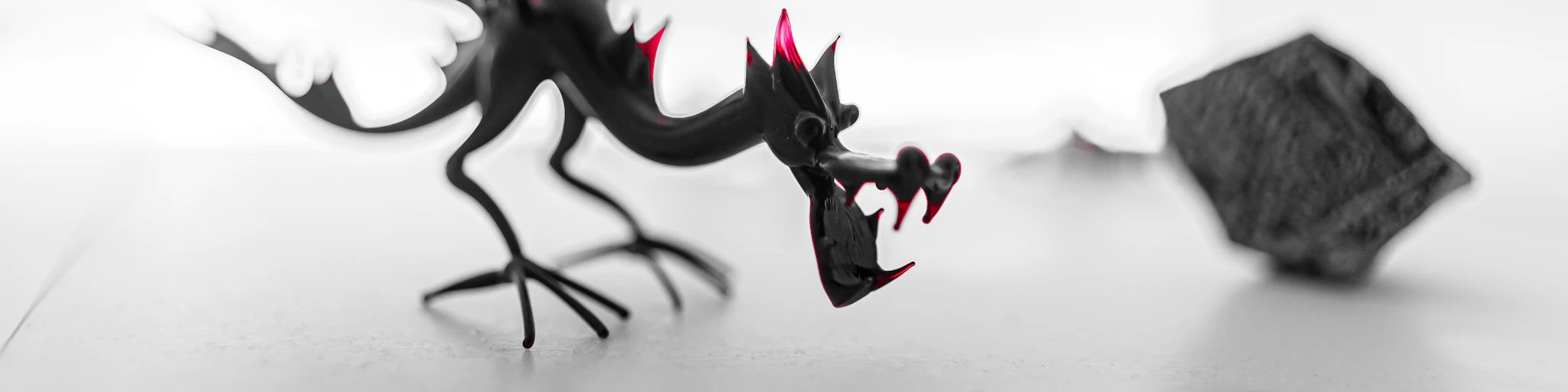 a black and white photo of a dragon figurine