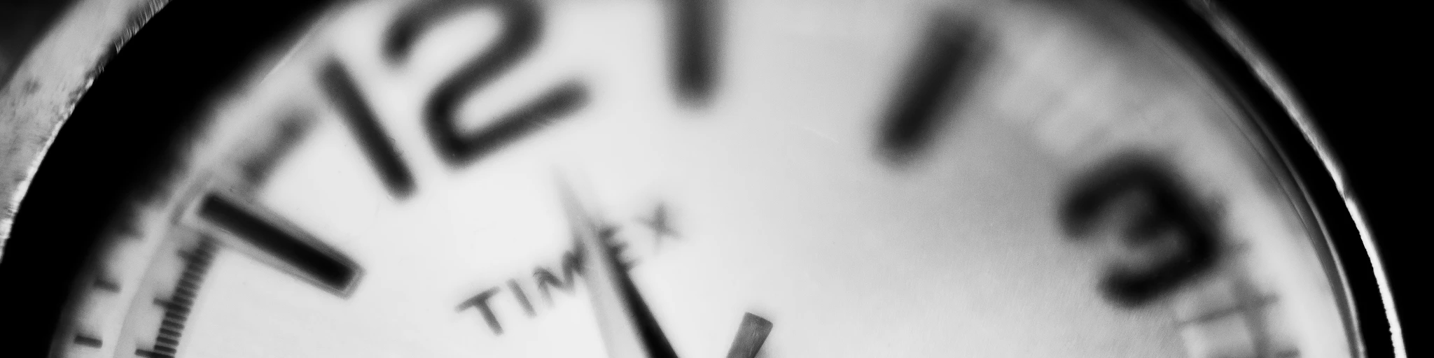 a black and white photo of a clock