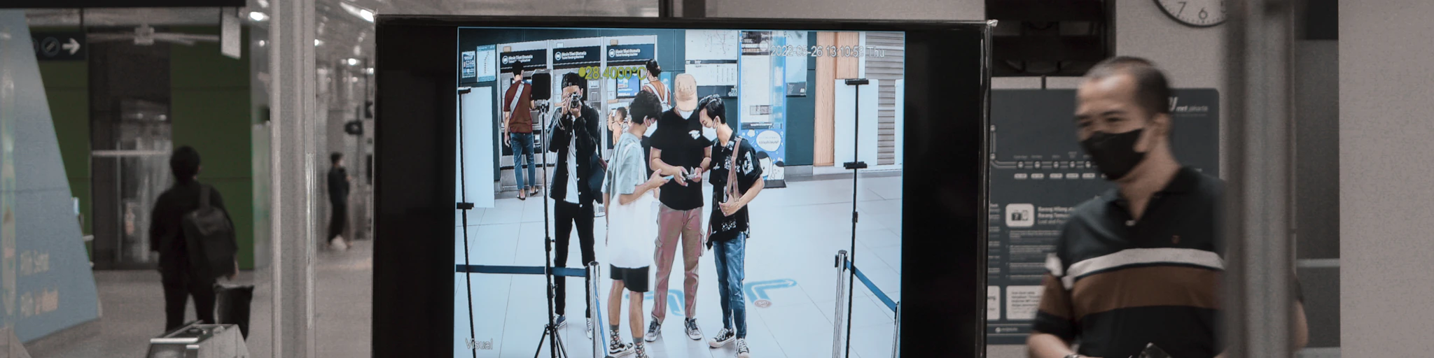 a man standing in front of a flat screen tv