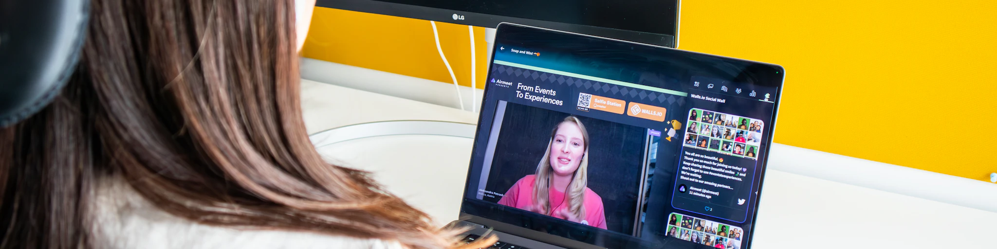 a woman sitting in front of a laptop computer
